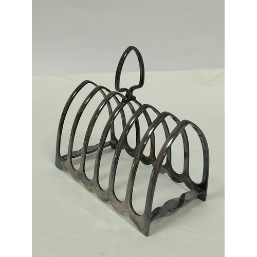 102 - Silver toast rack for six slices and a part fluted jug. (2).