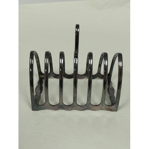 102 - Silver toast rack for six slices and a part fluted jug. (2).