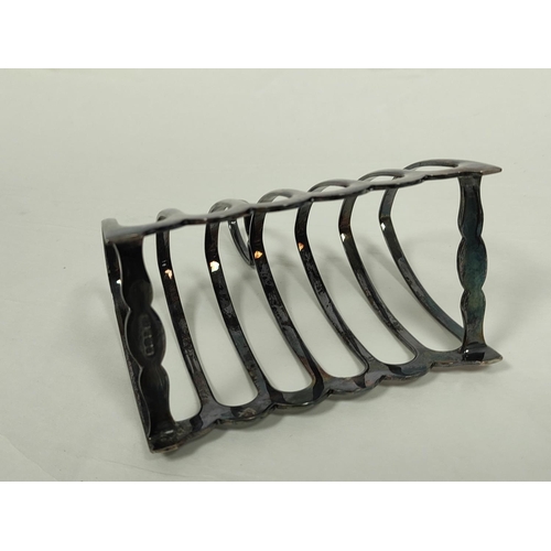 102 - Silver toast rack for six slices and a part fluted jug. (2).