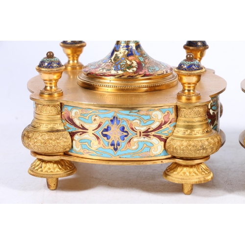 398 - Pair of French gilt metal and enamel clock garniture supporting vases of urn shape with mask handles... 