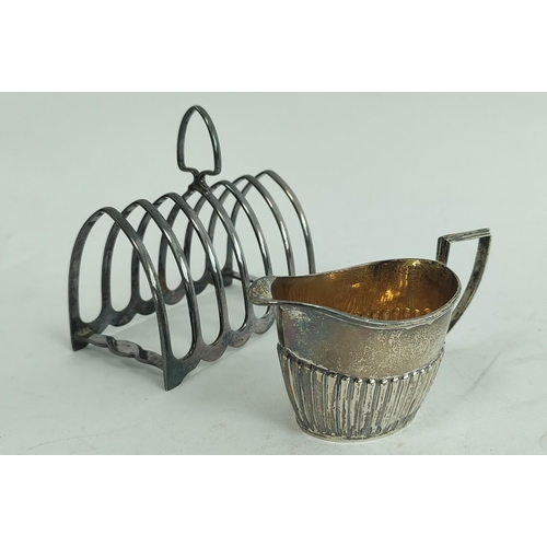 102 - Silver toast rack for six slices and a part fluted jug. (2).