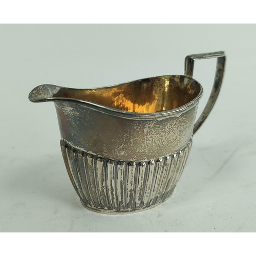 102 - Silver toast rack for six slices and a part fluted jug. (2).