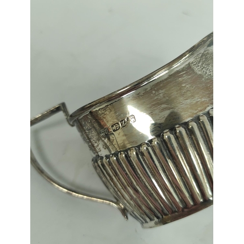 102 - Silver toast rack for six slices and a part fluted jug. (2).