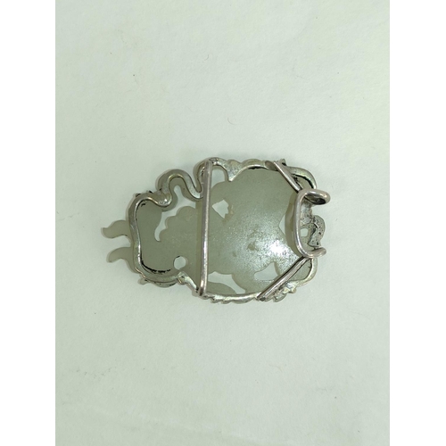 106 - Chinese celadon jade circular pendant and a similar buckle in two parts. (3).