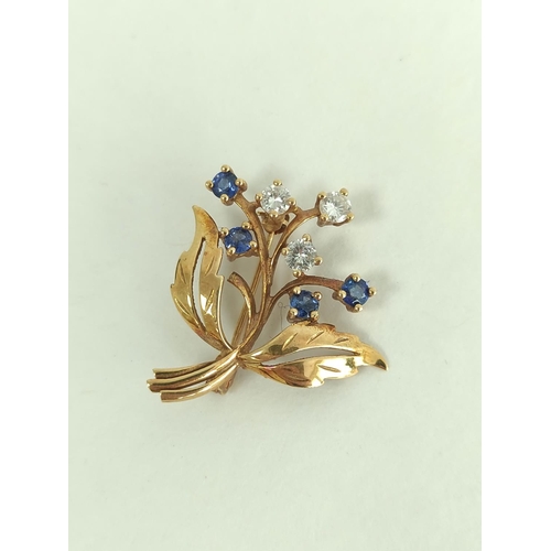 129 - 18ct gold spray brooch with three diamonds and four sapphires.