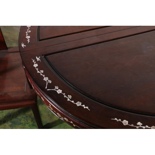 637 - A Chinese hardwood circular extending dining table with two leaves, 46cm each, mother of pearl inlay... 