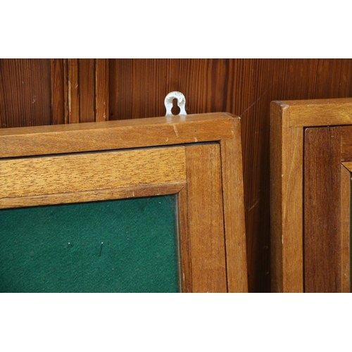 606 - Three mahogany framed noticeboards, with hinged and glazed doors, 92cm x 61cm.