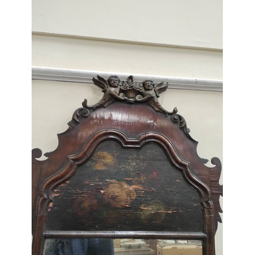 645 - Georgian wall mirror, the old rectangular plate surmounted by a painted blind panel in walnut fret f... 