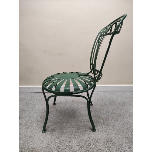 658 - Attributed to Francois Carre, a pair of green painted wrought iron cafe chairs with sunburst decorat... 