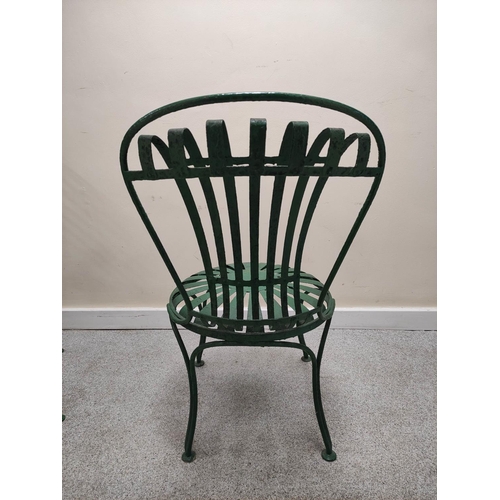 658 - Attributed to Francois Carre, a pair of green painted wrought iron cafe chairs with sunburst decorat... 