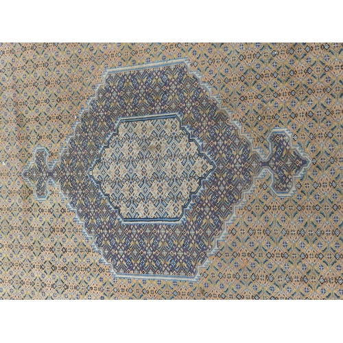 503 - Eastern carpet with central hexagonal lozenge in a diamond lattice field with stylised flowerhead bo... 