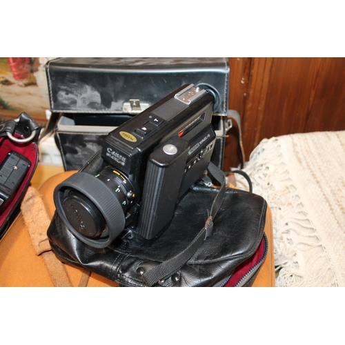 241 - Vintage cameras to include a Bolex 680, a Polaroid Land camera, a Minolta XL440, etc.