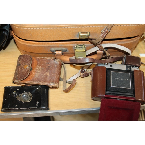 241 - Vintage cameras to include a Bolex 680, a Polaroid Land camera, a Minolta XL440, etc.