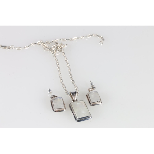 533 - Silver and moonstone pendant on chain and a pair of matching earrings.