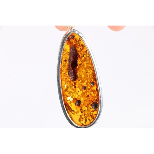 541 - Silver mounted amber pendant, a pair of matching earrings, another pair of similar earrings, and an ... 