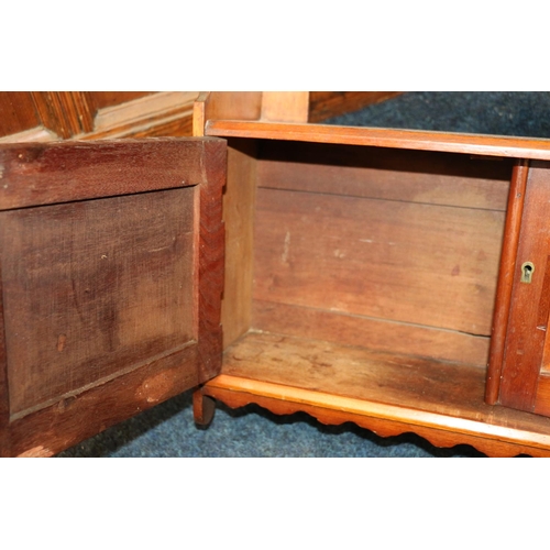 603 - Mahogany pine shelf, with single tier above pair of inlaid cupboard doors, over a moulded apron, 63c... 