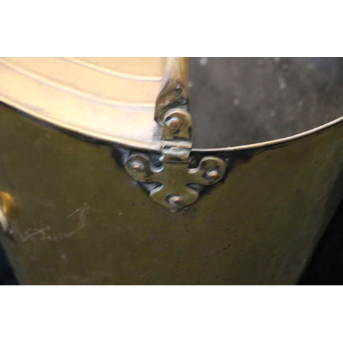 616 - Brass coal scuttle, with hinged handle, of tapering form, on circular base, 55cm with handle.