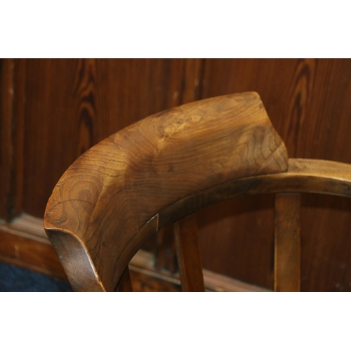 630 - Elm desk chair, with saddle seat, supports terminating in castors, 80cm.