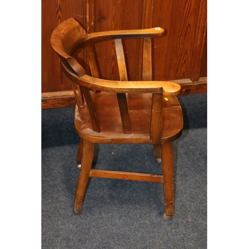 630 - Elm desk chair, with saddle seat, supports terminating in castors, 80cm.