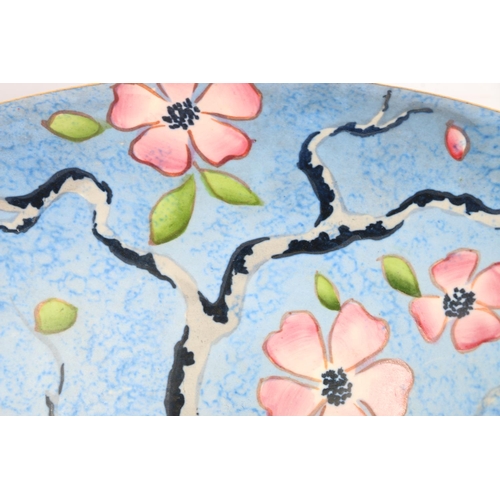 101 - Carlton Ware flaring footed bowl, decorated with pink flowers on blue ground, 27cm diameter.