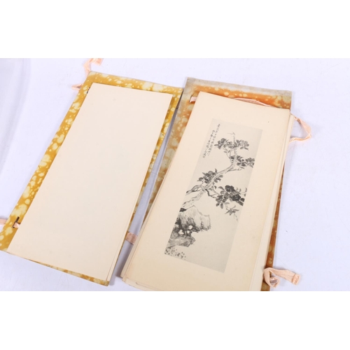 119 - Oriental folder containing prints.