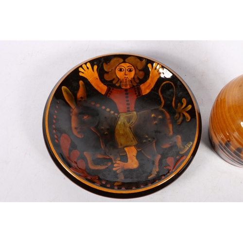 123 - Studio Pottery dish decorated with a man on a donkey, indistinct mark to base, 21cm diameter, and a ... 