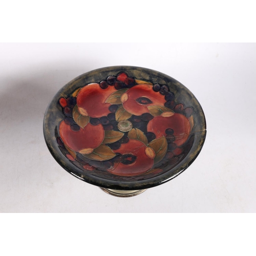 140 - Moorcroft plate, mounted on a metal stand, 14cm high x 22cm diameter., and a footed dish with glass ... 