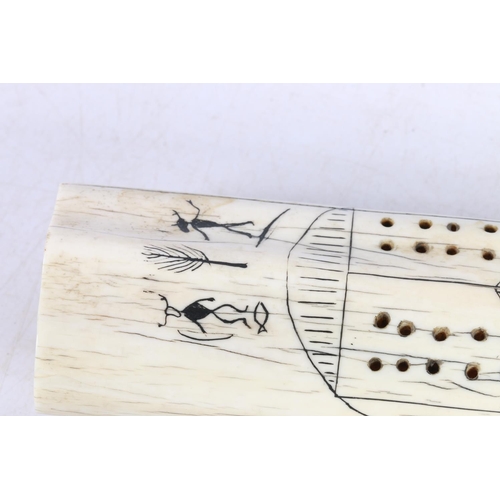 142 - Scrimshaw cribbage board of Inuit design, 33cm long.