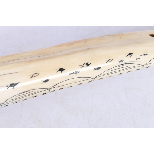 142 - Scrimshaw cribbage board of Inuit design, 33cm long.