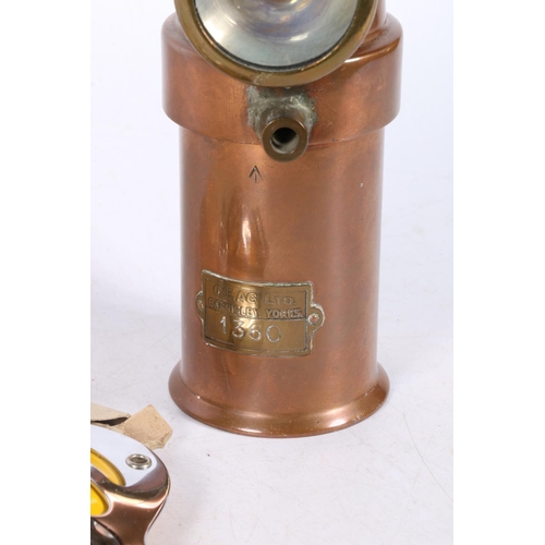 142A - The Ceag Miners Supply Co. Ltd copper lamp, with military crow's foot stamped to front, 17cm high, w... 