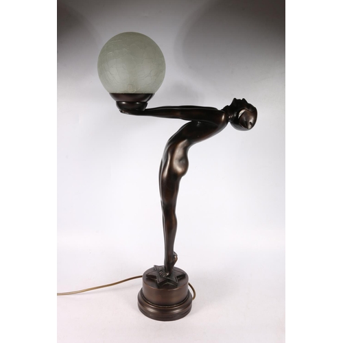 143 - Composite Art Deco style lamp ion the form of a female holding a globe, 68cm high.