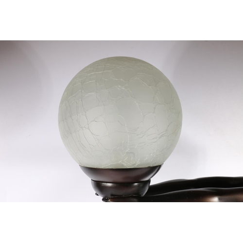 143 - Composite Art Deco style lamp ion the form of a female holding a globe, 68cm high.