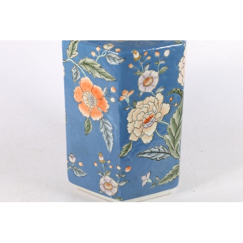 163 - Modern Chinese style jar and cover of hexagonal form, decorated with colourful flowers on blue groun... 