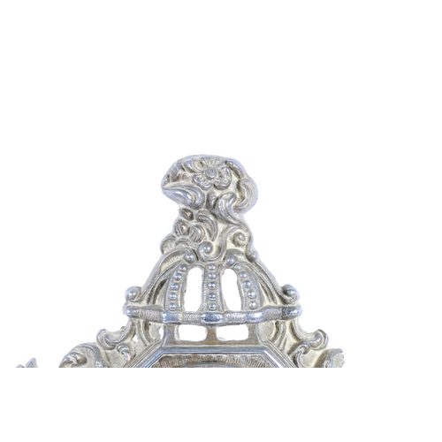 18 - Cast metal mantel clock of classical design, decorated with cherubs, 23cm high.