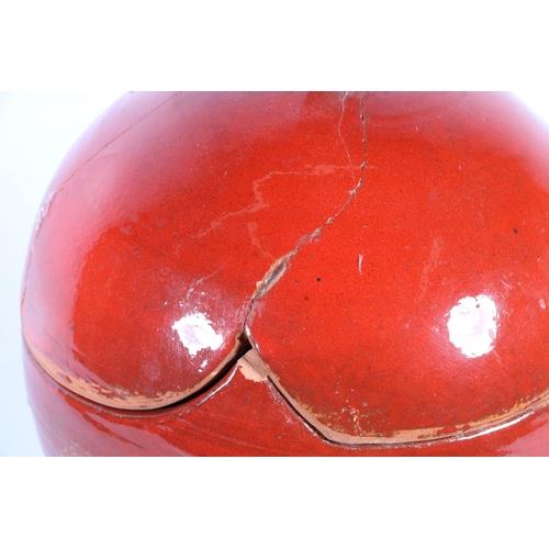 58 - Red glazed abstract Studio Pottery jar and cover, 32cm.  (a/f)