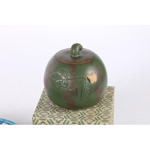 63 - Yixing jar and cover of pumpkin form, decorated with relief leaf, 7cm high, and an Iznik style terra... 