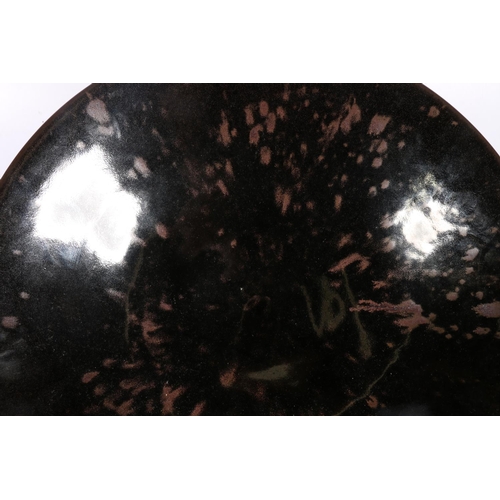 74 - Studio Pottery shallow bowl, decorated in black over brown glaze, 39cm diameter.