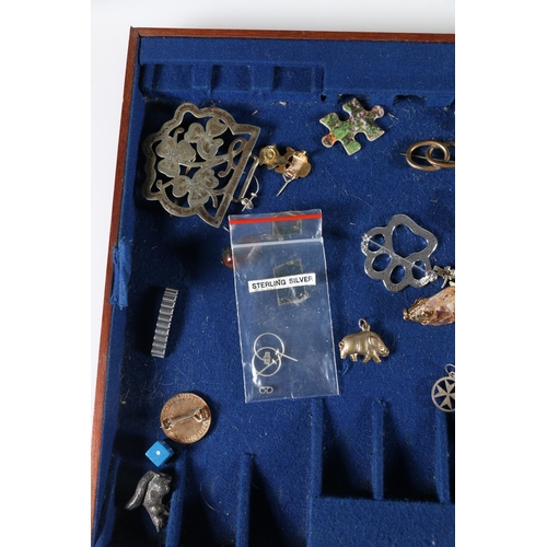 462 - Costume jewellery and charms, some silver, in mahogany canteen.