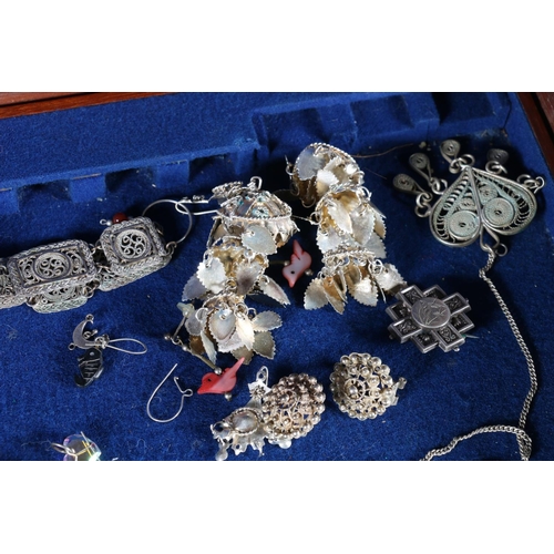 462 - Costume jewellery and charms, some silver, in mahogany canteen.