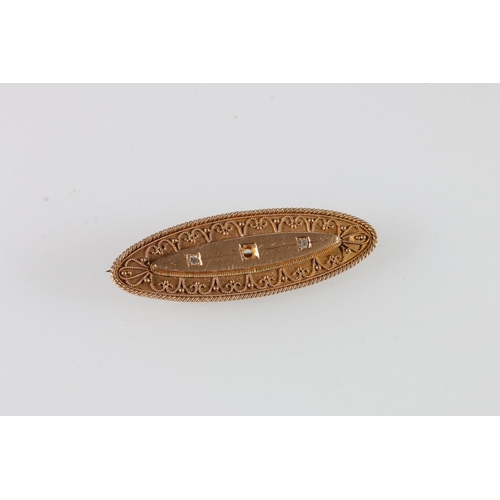 561 - 15ct gold navette shaped brooch with applied filigree work and two inset small round cut diamonds (c... 