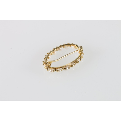 570 - 9ct gold mounted seed pearl set oval brooch, 1.8g.