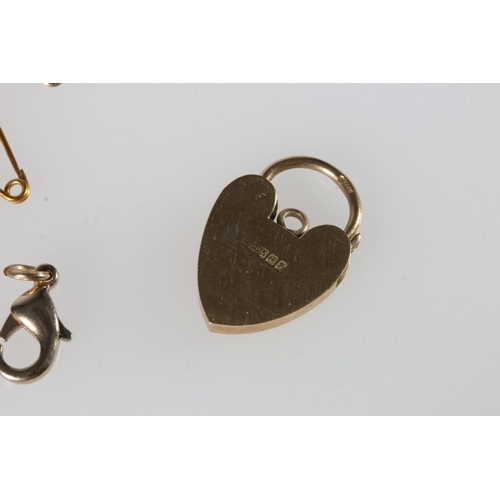 574 - 9ct gold heart shaped padlock 2.4g, a 9ct gold chain 1.4g, and two unhallmarked safety chains.