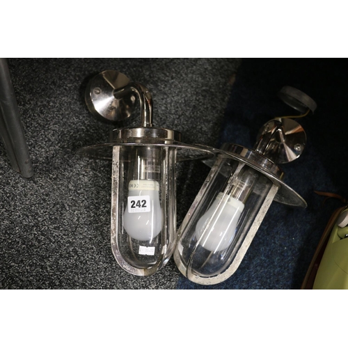 242 - Pair of chromed glass exterior wall lights.