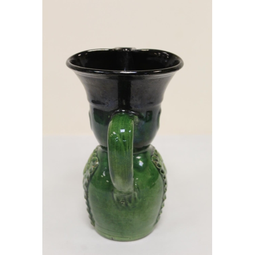 467 - Studio pottery bottle vase with owl mask head, twin scroll handles and green and brown glazes, unmar... 