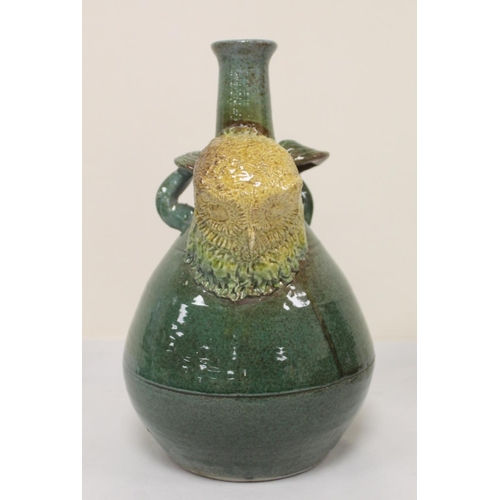 467 - Studio pottery bottle vase with owl mask head, twin scroll handles and green and brown glazes, unmar... 