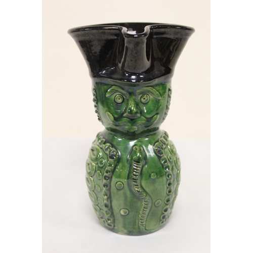 467 - Studio pottery bottle vase with owl mask head, twin scroll handles and green and brown glazes, unmar... 