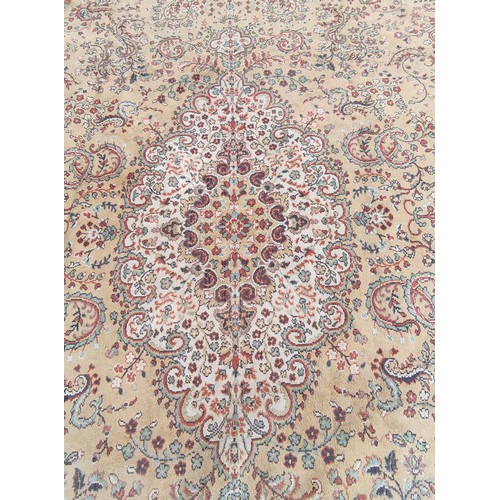 504 - Machine woven Eastern carpet with central lozenge and foliate scrolls in creams and browns, 355cm x ... 