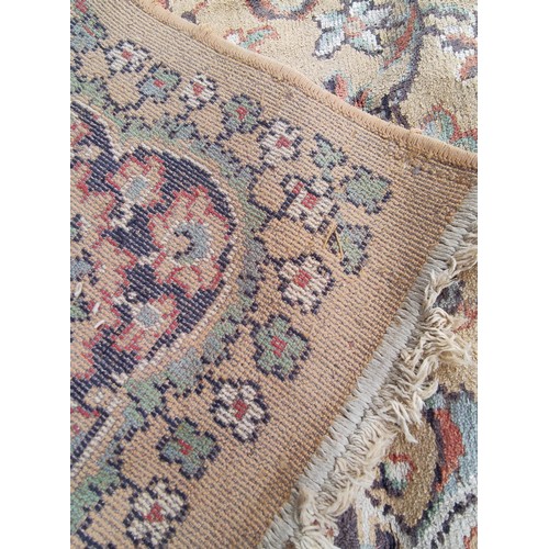 504 - Machine woven Eastern carpet with central lozenge and foliate scrolls in creams and browns, 355cm x ... 