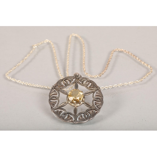 113 - Hallmarked silver and citrine set pierced circular pendant; on white metal chain; 14.8g gross weight