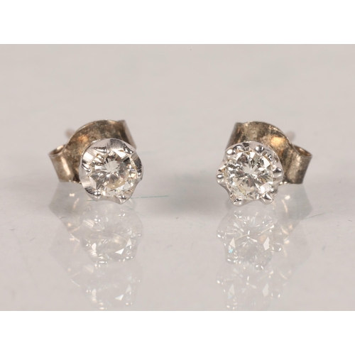 63 - Pair of yellow metal mounted diamond solitaire earrings